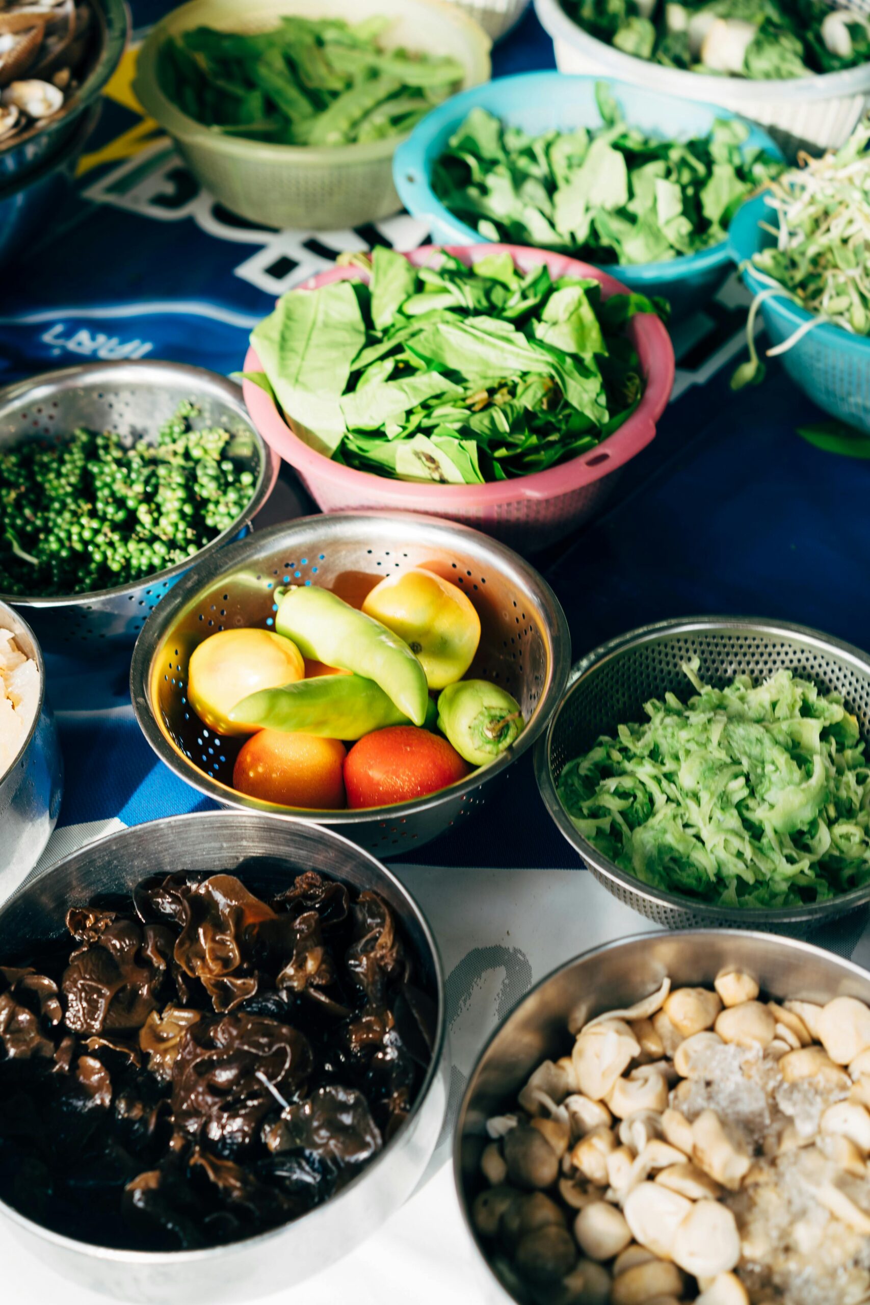 Fresh green vegetables in small bowls prepared as ingredients for sustainable recipes